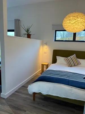 a bedroom with a bed and a window at Cicero's Lodge in Padstow