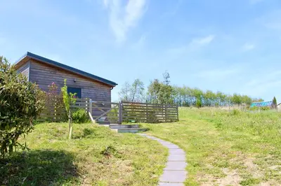 a path leading to a building in a field at Cicero's Lodge in Padstow
