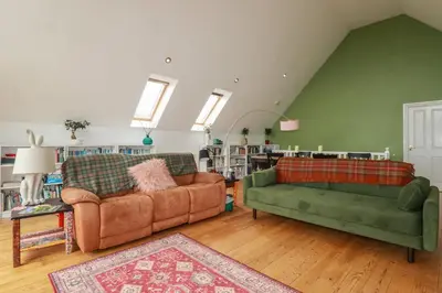 a living room with two couches and a rug at 6 The Links in Penzance