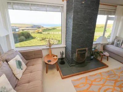 a living room with a couch and a fireplace at Coastman's Nest in Newquay