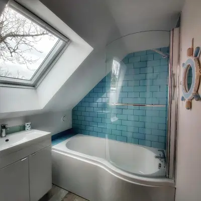 a bathroom with a tub and a sink and a window at Heart of Kernow Holiday Home in Bugle