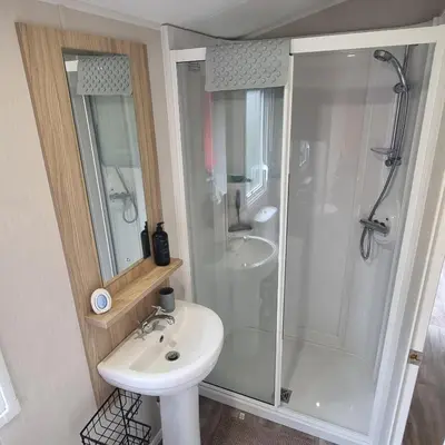 a bathroom with a shower and a sink at 7 Bays 6 Berth Willerby Molton Caravan in St Merryn