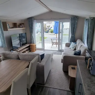 a living room with a couch and a table at 7 Bays 6 Berth Willerby Molton Caravan in St Merryn