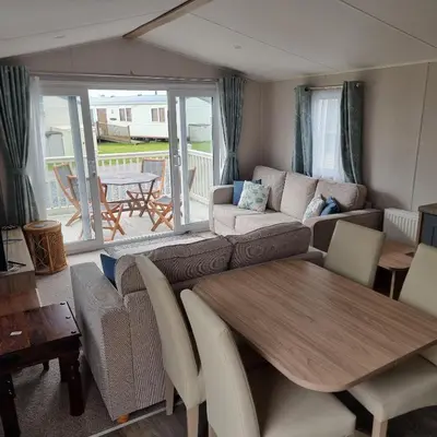 a living room with a couch and a table at 7 Bays 6 Berth Willerby Molton Caravan in St Merryn
