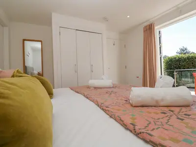 a bedroom with a bed with two pillows on it at Azure Retreat at Una in St Ives