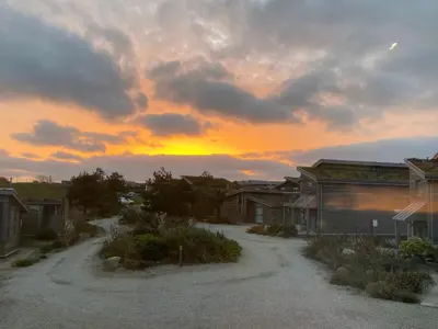 a sunset over a village with a dirt road at Azure Retreat at Una in St Ives