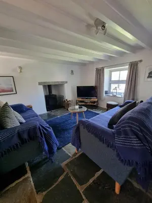 a living room with two beds and a couch at North Cornwall character cottage, sleeps 5, close to coast in Delabole
