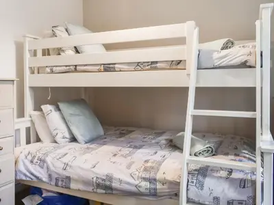 a bunk bed room with two bunk beds at Low Tide in Looe