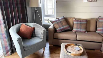 a living room with a couch and a chair at Manor Lake Lodge Exclusive luxury lodge retreat in Saint Tudy