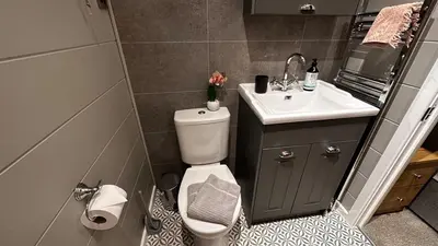 a small bathroom with a toilet and a sink at Manor Lake Lodge Exclusive luxury lodge retreat in Saint Tudy