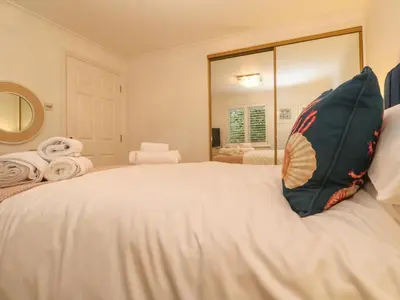 a white bed with a pillow on top of it at Sandwaves in St Ives