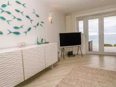 a living room with a flat screen tv and a flat screen tv at Sandwaves in St Ives