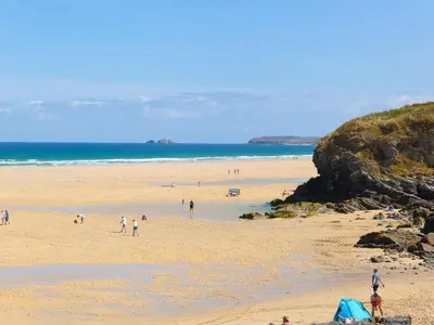 a group of people on a beach near the ocean at Ty Metheven in Camborne