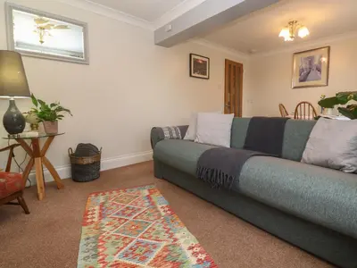 a living room with a couch and a table at Ty Metheven in Camborne