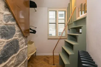 a winding staircase in a room with a window at She Sells Sanctuary in St Ives