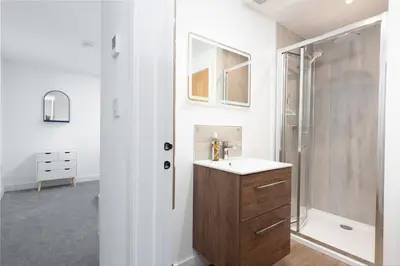 a bathroom with a sink and a shower at Hednes Barn in Crowan