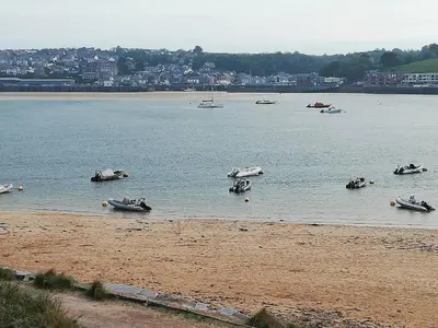 a group of boats in the water on a beach at Badgers nestled in a cozy corner of the park in Wadebridge