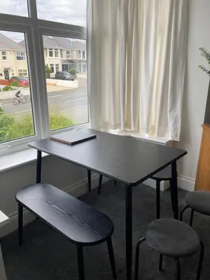 a desk with a laptop on it in front of a window at Newquay Beachcomber 2 Bedroom Apartment in Saint Columb Minor