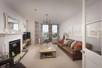 a living room with a couch and a fireplace at Dolly's Plaice, Fowey in Fowey