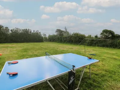 a ping pong table in the middle of a field at The Packing House in Penzance