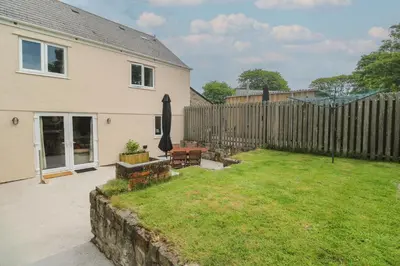 a backyard of a house with a fence at The Packing House in Penzance