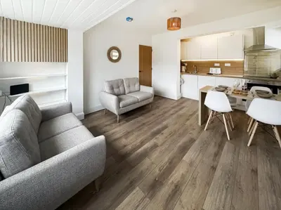 a living room with a couch and a table at Tide and Treth in Newquay