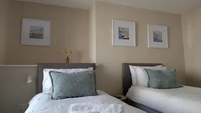 two beds sitting next to each other in a bedroom at Duke of Cornwall in St Austell