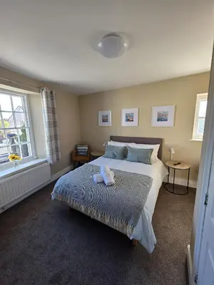 a bedroom with a large bed and a window at Duke of Cornwall in St Austell