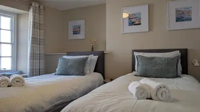 two beds sitting next to each other in a bedroom at Duke of Cornwall in St Austell