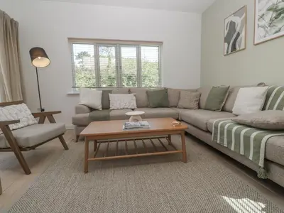 a living room with a couch and a coffee table at Kerrek Lodge in Falmouth