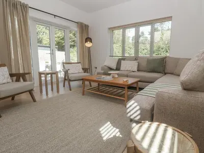 a living room with a couch and a table at Kerrek Lodge in Falmouth