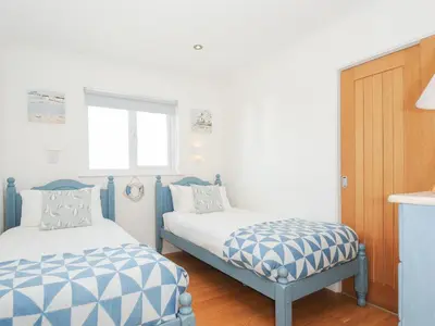 a bedroom with two beds and a window at Atlanta in Tintagel