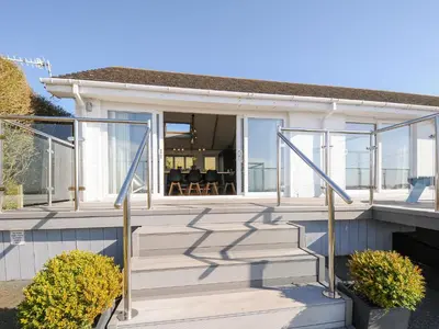 a house with glass doors and a porch at Atlanta in Tintagel
