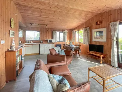 a living room with a couch and a table at The Hut Hotel in Falmouth