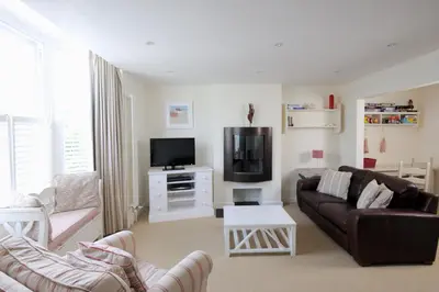 a living room with a couch and a tv at Cliff House, Cornwall in Padstow