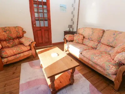 a living room with a couch and a coffee table at Carolyns Cottage in Penzance