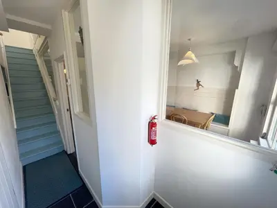 a hallway with a mirror on the wall at Chy Meor - a stonesthrow away from Porthmeor Beach in St Ives