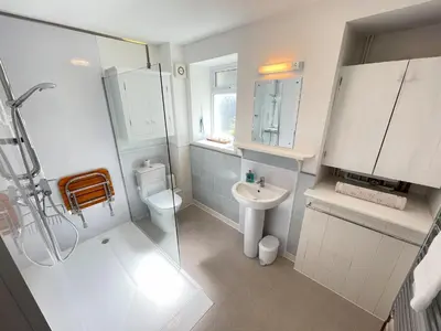 a white bathroom with a sink and a toilet at Chy Meor - a stonesthrow away from Porthmeor Beach in St Ives