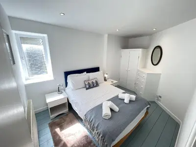 a bedroom with a bed with two towels on it at Chy Meor - a stonesthrow away from Porthmeor Beach in St Ives
