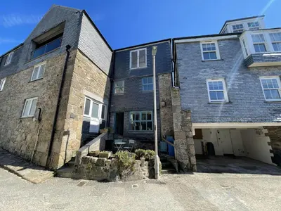 a large brick building with a courtyard in front of it at Chy Meor - a stonesthrow away from Porthmeor Beach in St Ives