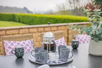 a table with cups and a coffee maker on it at 4 Bed in St. Keverne oc-t31085 in Saint Keverne
