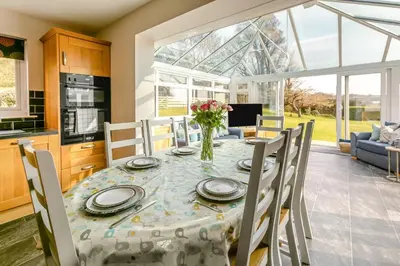 a kitchen and dining room with a table and chairs at 4 Bed in St. Keverne oc-t31085 in Saint Keverne