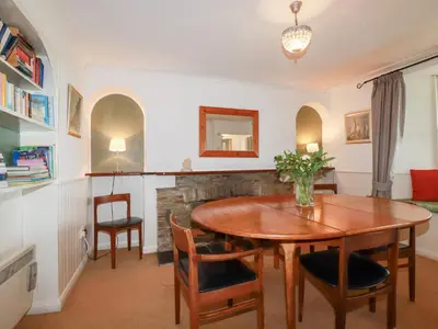 a dining room with a wooden table and chairs at Nanvivian in Feock