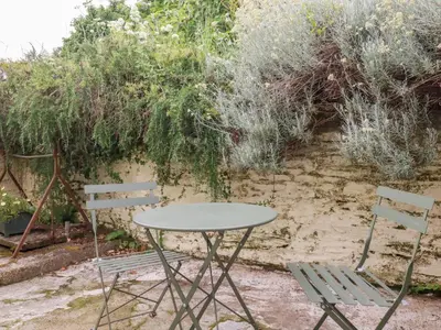 a table and two chairs in a garden at Nanvivian in Feock