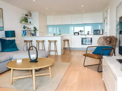 a living room with a couch and a table at 4 Ocean Gate in Newquay