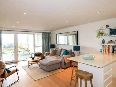 a living room with a couch and a table at 4 Ocean Gate in Newquay