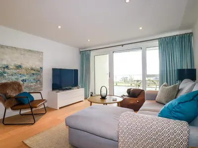 a living room with a couch and a tv at 4 Ocean Gate in Newquay