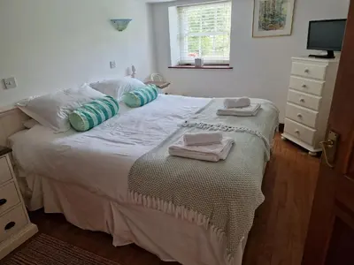 a bedroom with a bed with towels on it at Rosemaddon in Newquay