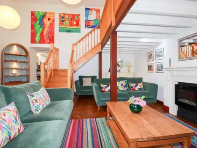 a living room with green couches and a table at Rosemaddon in Newquay