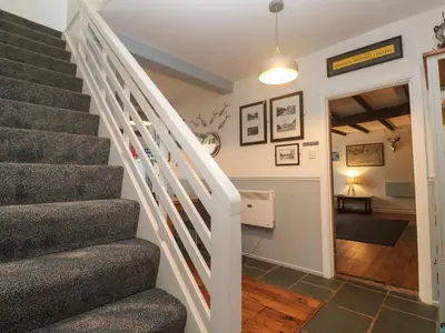 a staircase in a home with a stair case at Mews Cottage in Tintagel